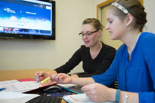 two female students working together on a problem