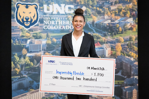 student holding a check in professional attire