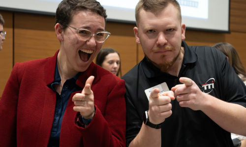 student posing for a photo with an employer